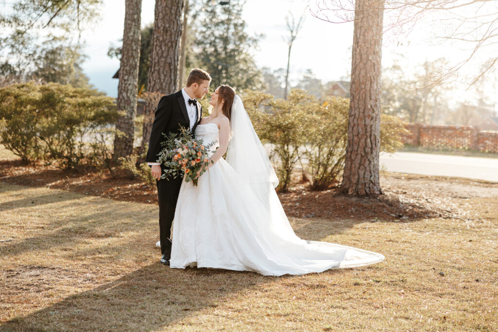 Groom and bride looking at each other in couple portrait.